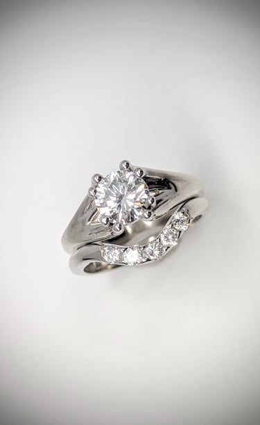 White gold solitaire diamond engagement ring complimented with a matching wedding band. 