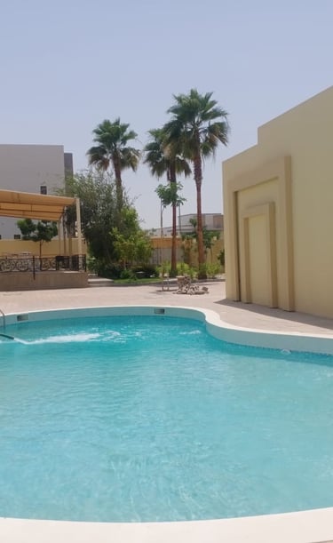 a pool with a swimming pool and a lounge area