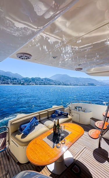 a boat with a table and chairs on the deck