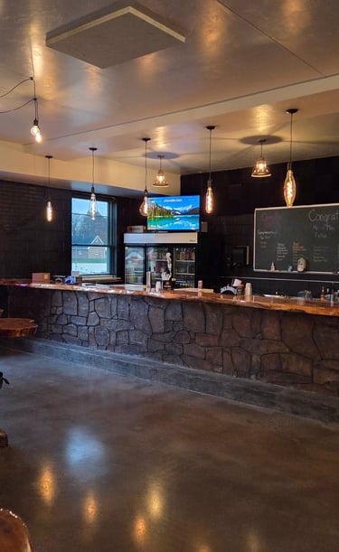 Brickyard Events bar featuring warm brick accents and a natural wood bar top, styled for wedding and