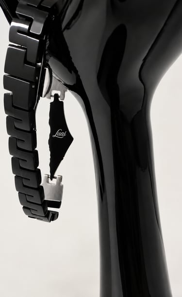 A black stainless steel Luai watch band featuring a Palestine map charm displayed on a glossy stand.