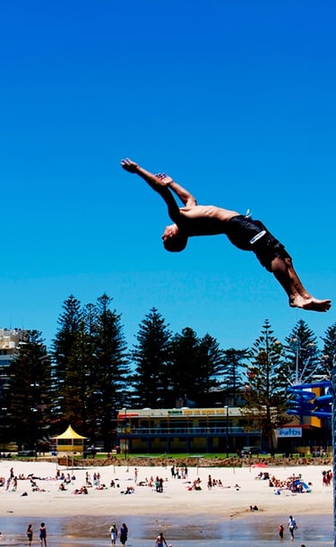 A person diving off the Glenelg Jetty