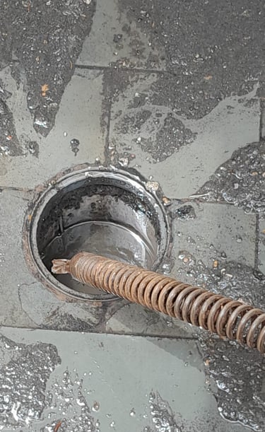 a drain hole in a drain with a metal pipe