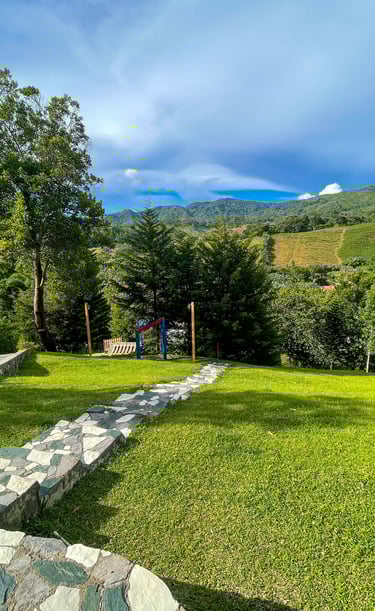 a grassy field with stone steps leading to a grassy area