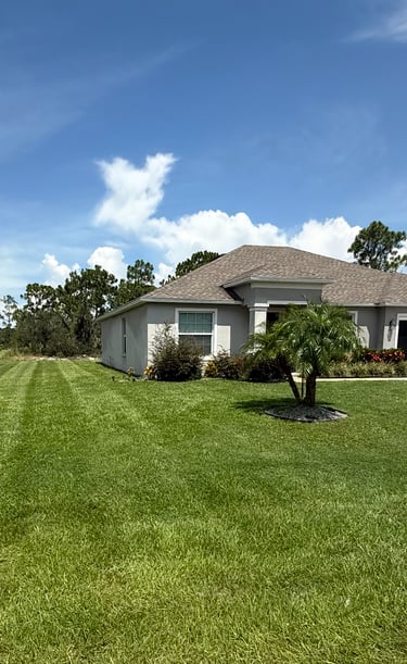 a house with a car parked in the grass