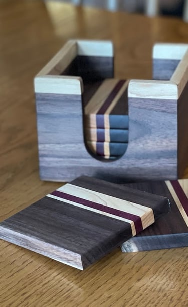 Handcrafted coaster set made from black walnut, maple and purple. heart.