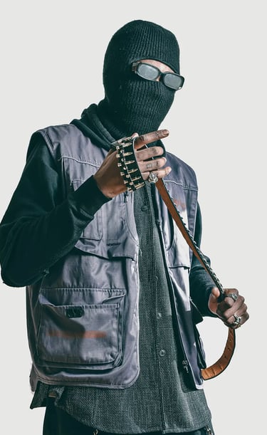 Studio shooting of a man in a black jacket and a mask and holding a belt