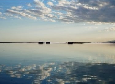 a boat on the water with clouds in the background