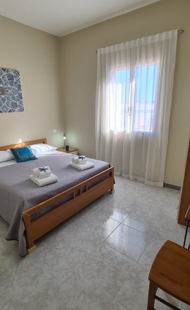 a bedroom with a bed and a chair