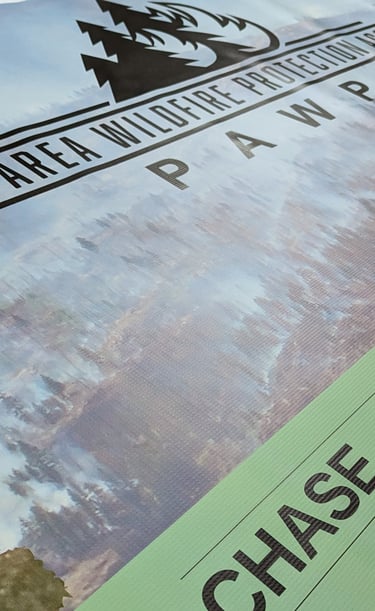 A large printed banner featuring a colorful design and bold text, hanging on a wall at an event, pro