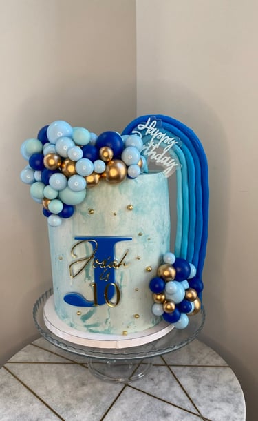 a cake with a blue and gold cake topper