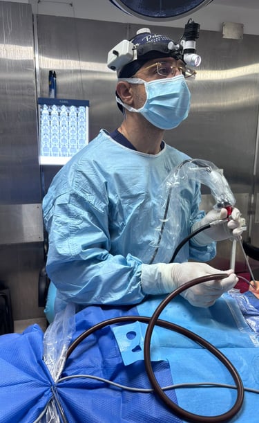 Surgeon performing endoscopic sinus surgery using specialized tools and a surgical headlamp.