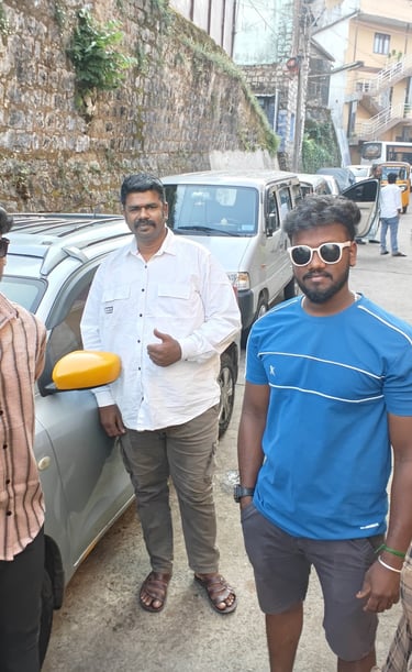 ​"Satisfied customers taking a group photo outside their South India Drop Taxi outstation cab during