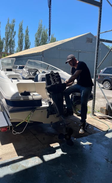 Mobile marine technician changing gear oil on a stern drive.