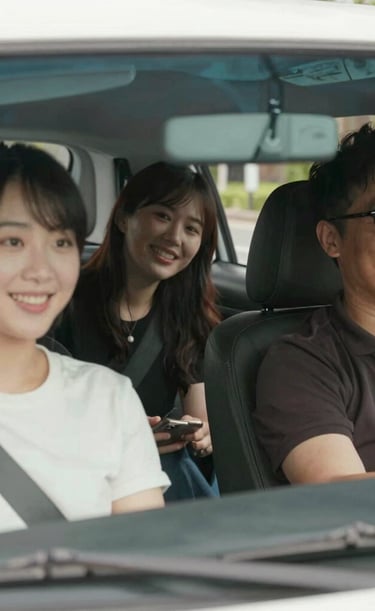 Professional driver greeting a smiling passenger near Fort Sill with a friendly wave.