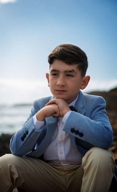 a young man in a blue suit and a white shirt