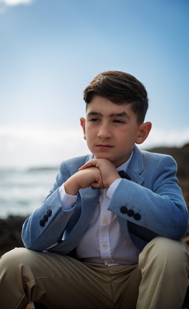 a young man in a blue suit and a white shirt