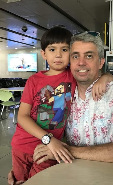a man and a boy sitting at a table there faces sad as they are seperated for 8 years