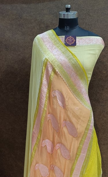 a chiffon saree with a yellow and peach pallu