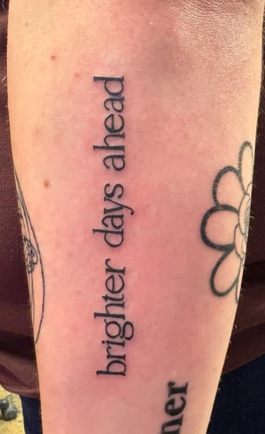 a tattoo on arm with beautiful block style lettering