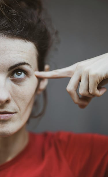 woman pointing to her head