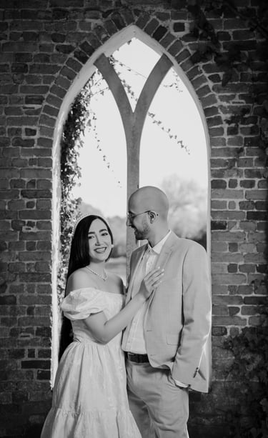 Couple standing in a brick archway during their Surrey engagement shoot by Fred Art Studio.
