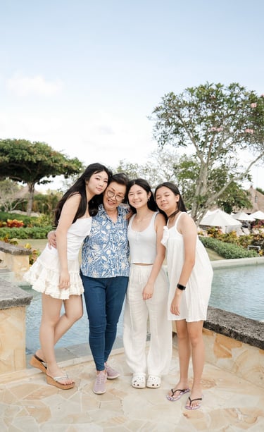 Three sisters walking together naturally during a relaxed family photography session at Ayana Jimbaran Bali