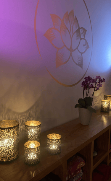 a table with candles and lit with purple light