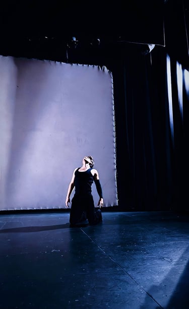 Contemporary dance practice exploring light and shadow on stage, Madrid 2026