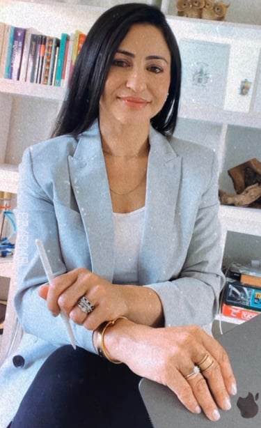 a woman sitting on a chair with a laptop
