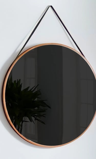 A mirror hangs on a wall with a darkened reflection, prompting the viewer to see their face