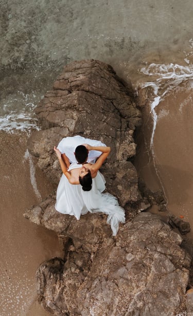 Bride and groom taking wedding photos on cobblestone streets, Perast