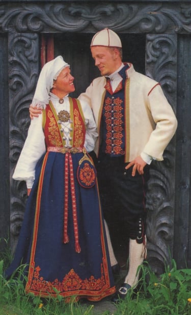A woman and a man looking at each other in bunad
