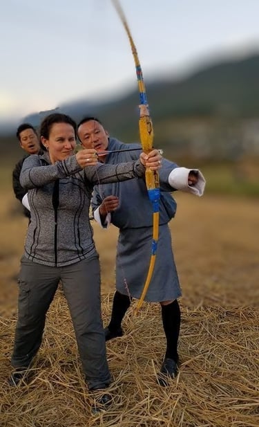 drukyul_delights_ceo_with_guest_experiencing_archery_session_in_punakha_bhutan