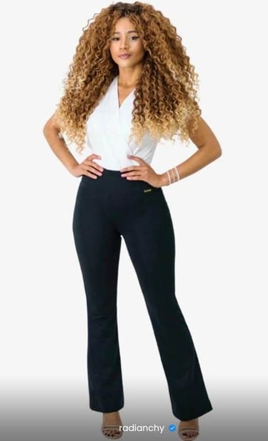 a woman in a white shirt and black pants