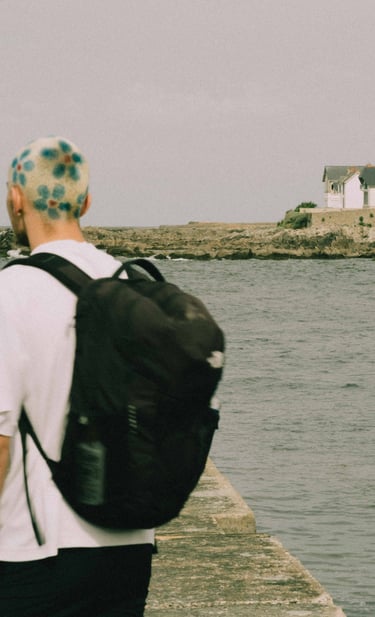 a man with a backpacker on a pier