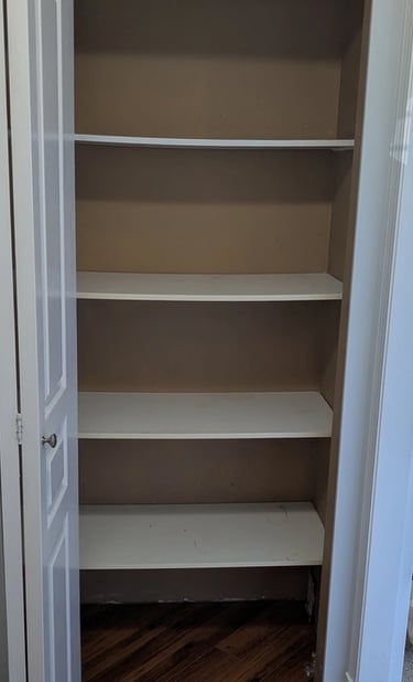 Old kitchenware closet, empty: just sagging shelving