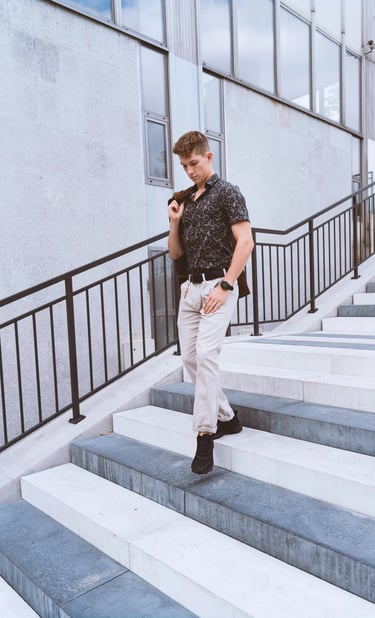 Portrait photo of a young man on the stairs in an industrial environment