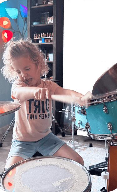 little girl playing blue drums