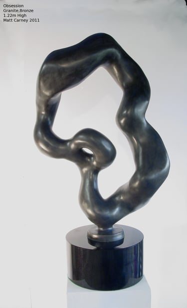 an abstract bronze sculpture on a black granite base