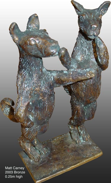 a statue of two dogs telling each other to be quiet