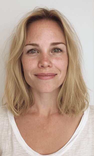 Soft champagne blonde colour transformation with long layered styling.
