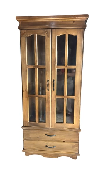 a cabinet with a glass door and a drawer