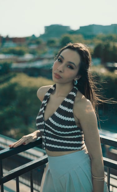 a woman in a striped top and skirt