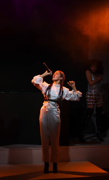 a woman in a white dress and a microphone