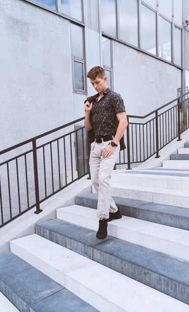 Portrait photo of a young man on the stairs in an industrial environment