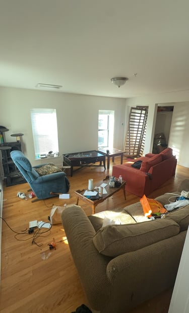 Estate home filled with furniture and clutter before junk removal cleanout
