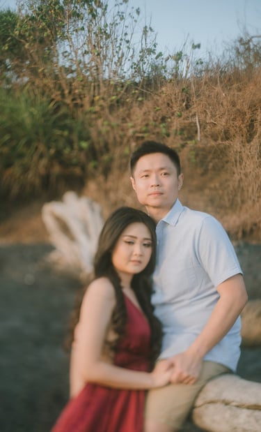 Intimate couple portrait in soft sunset light at Pantai Nyanyi Bali.