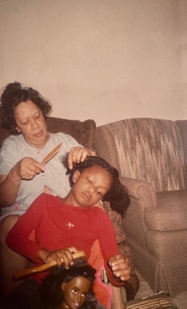 Granny braiding my hair while I braid a doll's hair