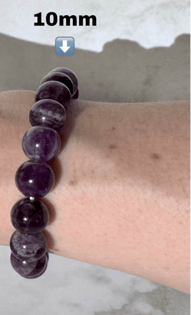 The first half a photo of a wrist with 2 amethyst crystal bracelets on it,this side is the 10mm size